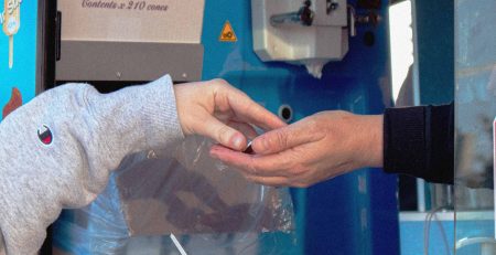 Cannabis customer exchanging products with a dispensary vendor